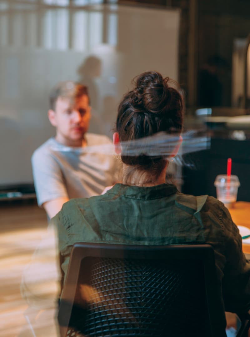 Two people in conversation during a workshop session.